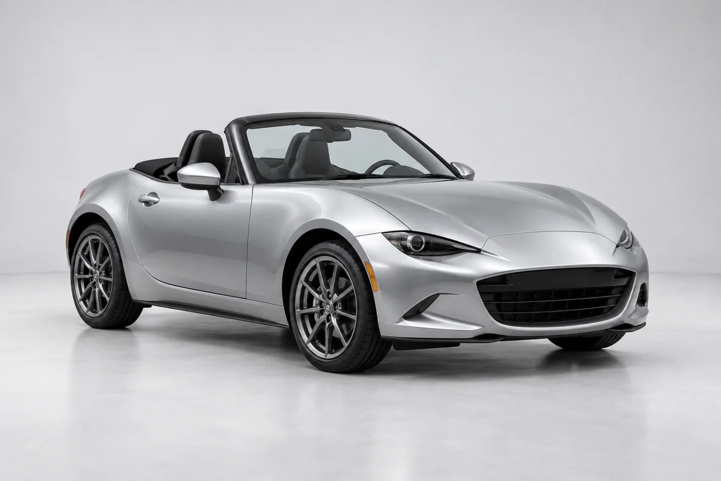 Illustrative reference-image example: a complete silver sports roadster photographed at a three-quarter angle on a clean studio background